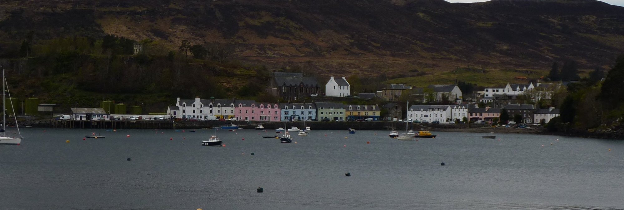 The distinctive, colourful houses of Portree across the bay