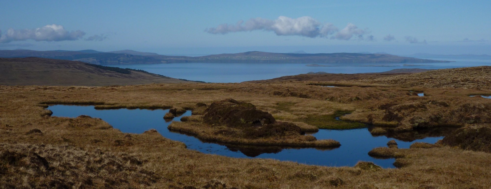 Across the tiny lochan on Beinn Edra towards the Waternish peninsula