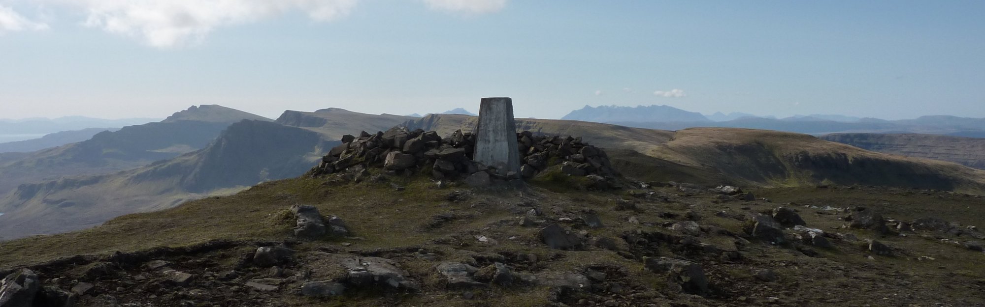 Trig point and shelter on summit of Beinn Edra, with the Storr far left behind